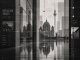 Black-and-white Berlin cityscape with reflections and systemic graphic elements.